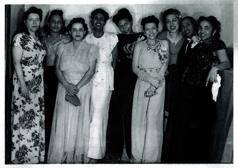 Several women in formal wear standing next to each other.