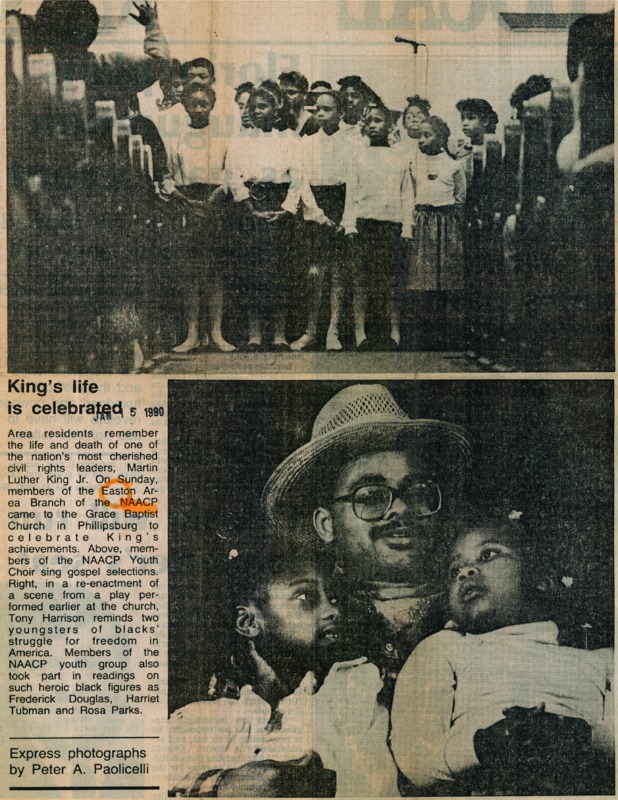 Newspaper clipping featuring a group of singing children in white dresses and a man in a hat and glasses hugging two girls.

