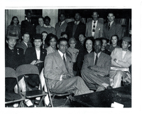 Several individuals in formal wear sitting.