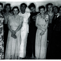Several women in formal wear standing next to each other.
