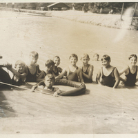 Several children standing above water.