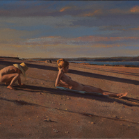 A nude woman reclining on a blue towel, supine on a beach. A nude child playing in the sand is crouched behind her. 
