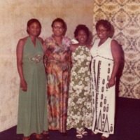 Four women in holiday dresses.