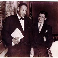 Two men in suits standing next to each other.